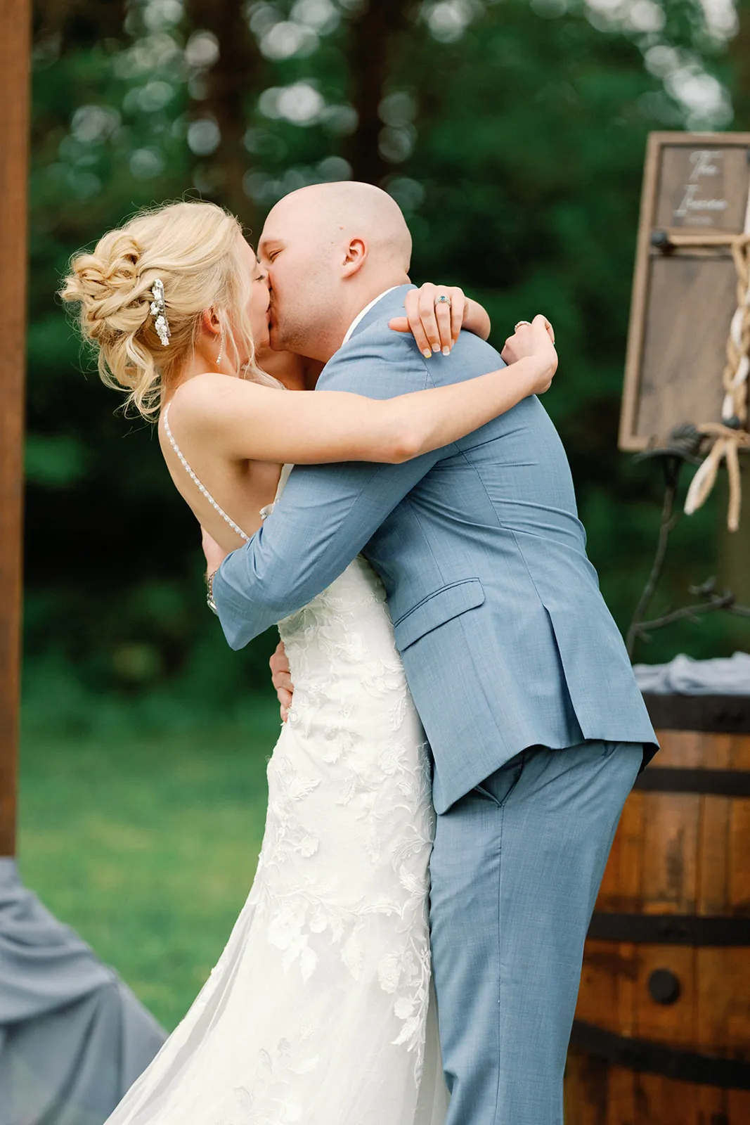 Colette and Sebastian hugging and kissing outdoors