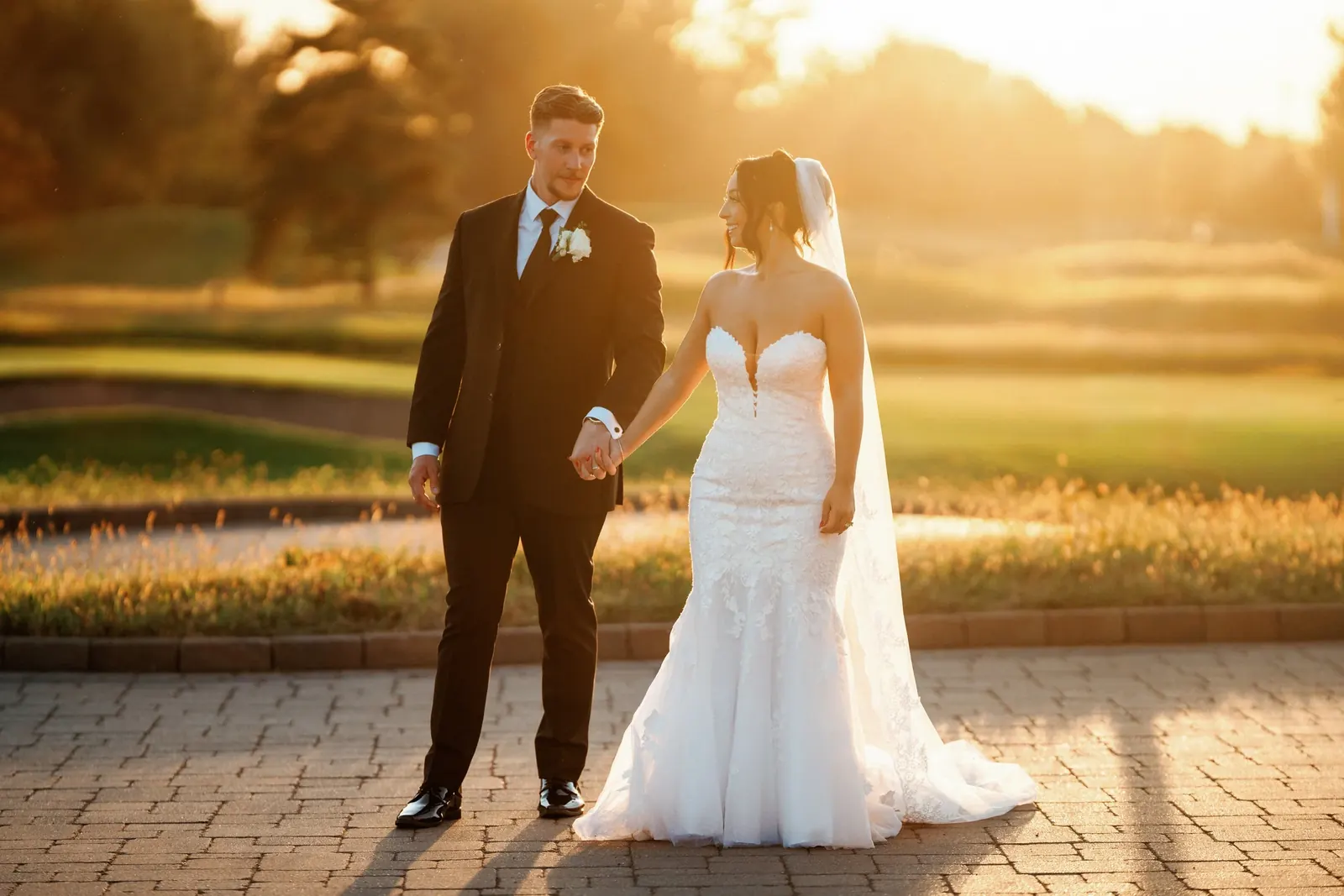 A couple holding hands at golden hour