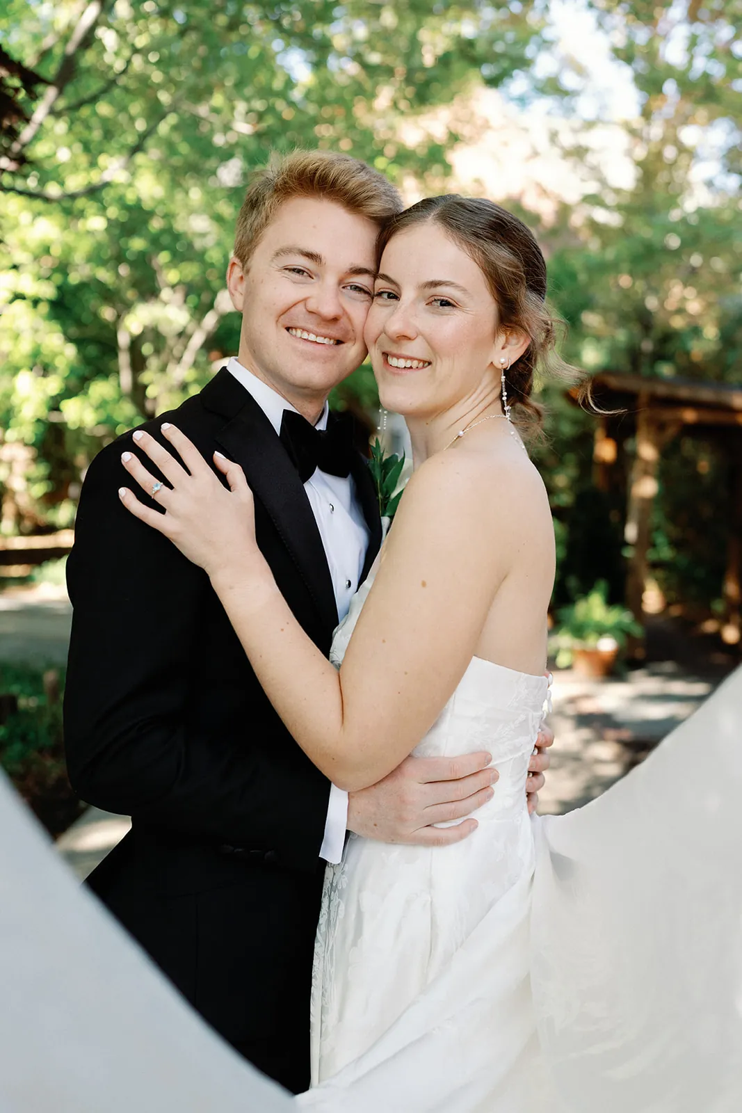 Klarisa and Sam embracing and smiling in a garden