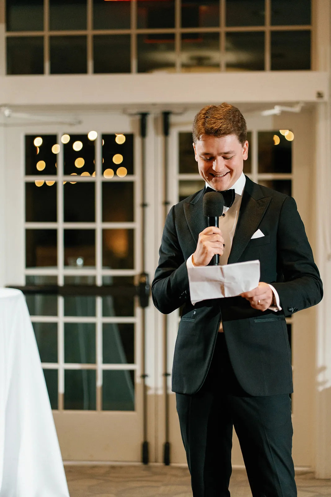 A groom giving a toast into a microphone